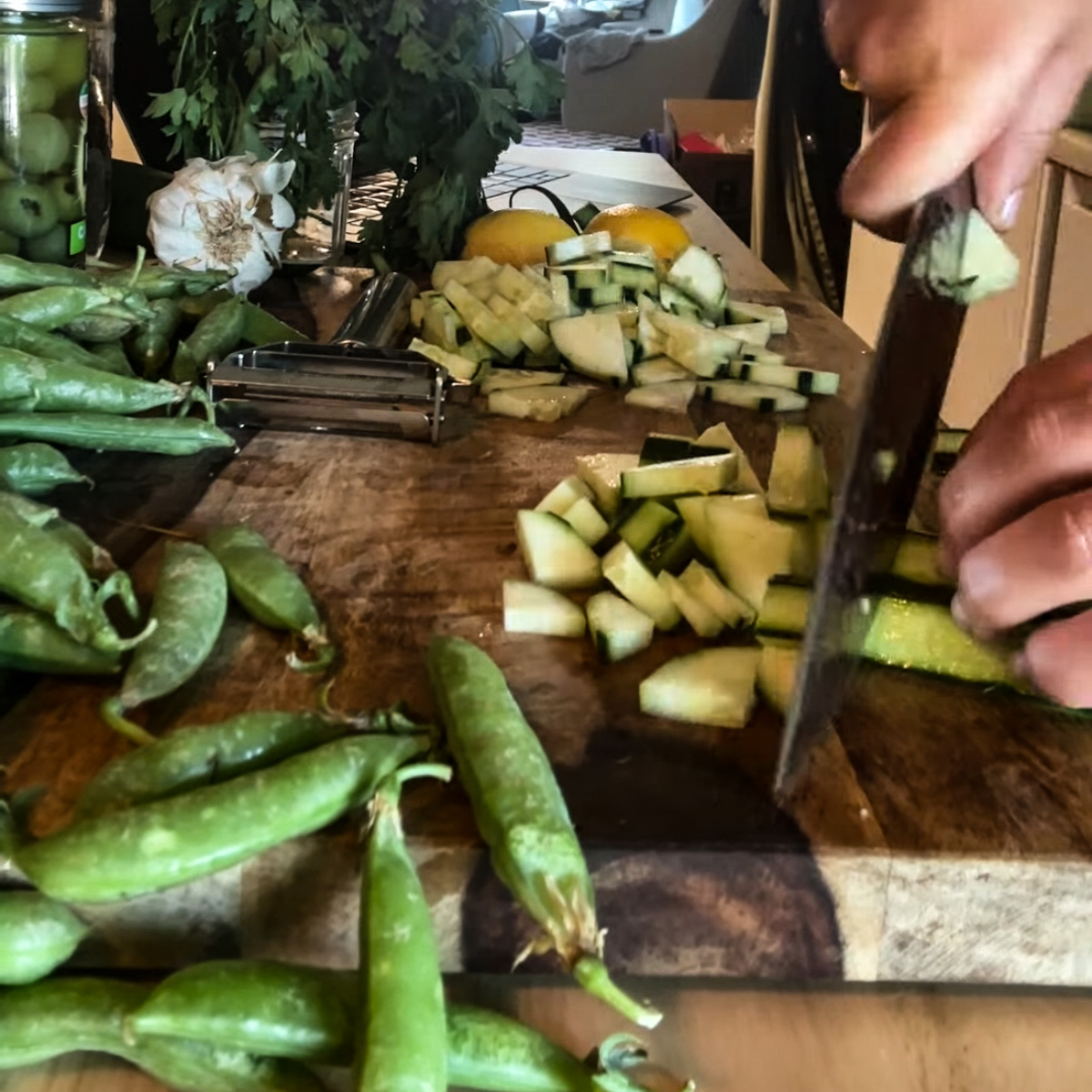 chopping all snap peas and cucumber
