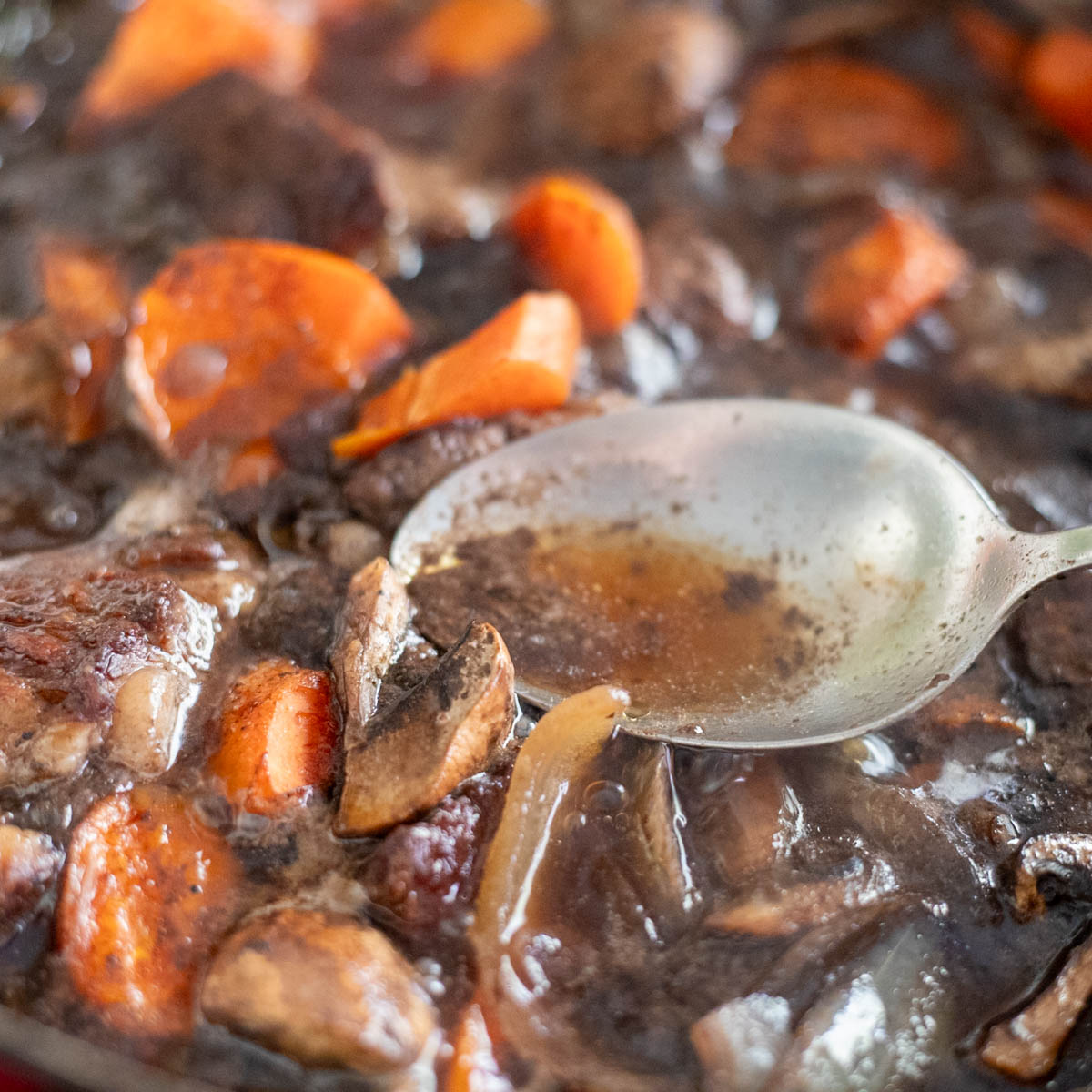 Braising the meat and adding the mushrooms.