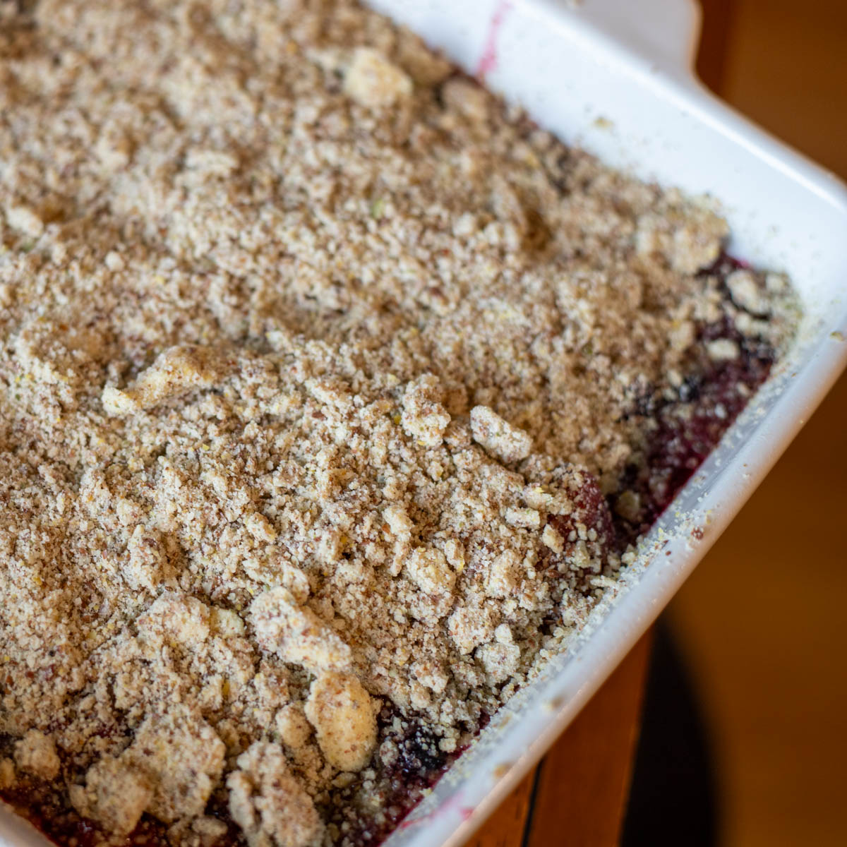 Layers of crust, berries, and crumble on top.
